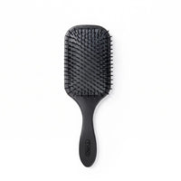 Front view of the black TYMO Paddle Brush showing nylon ball-tipped bristles and ergonomic handle against a plain white background.