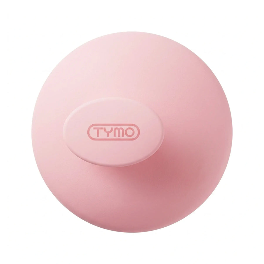 Top-down view of the round pink TYMO scalp massager brush displaying the embossed brand logo on the ergonomic handle.