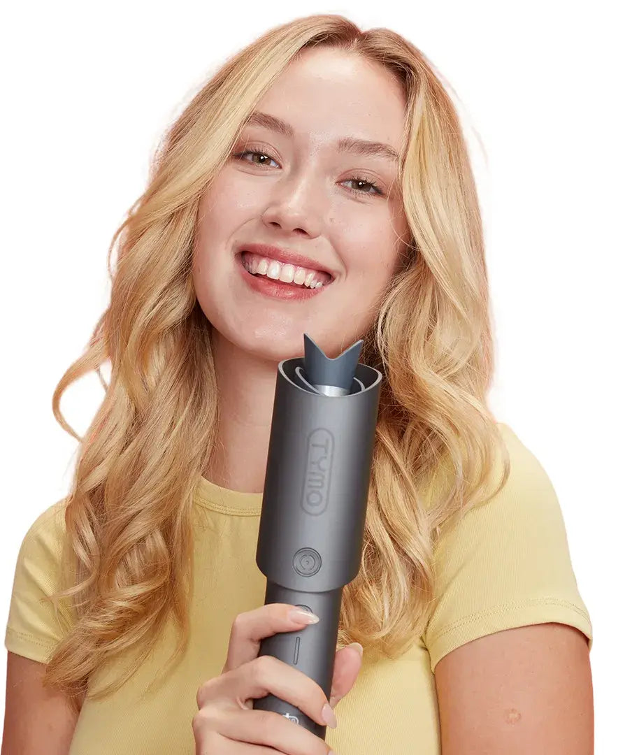 Model holding TYMO CURLPRO automatic curling iron for hair styling.